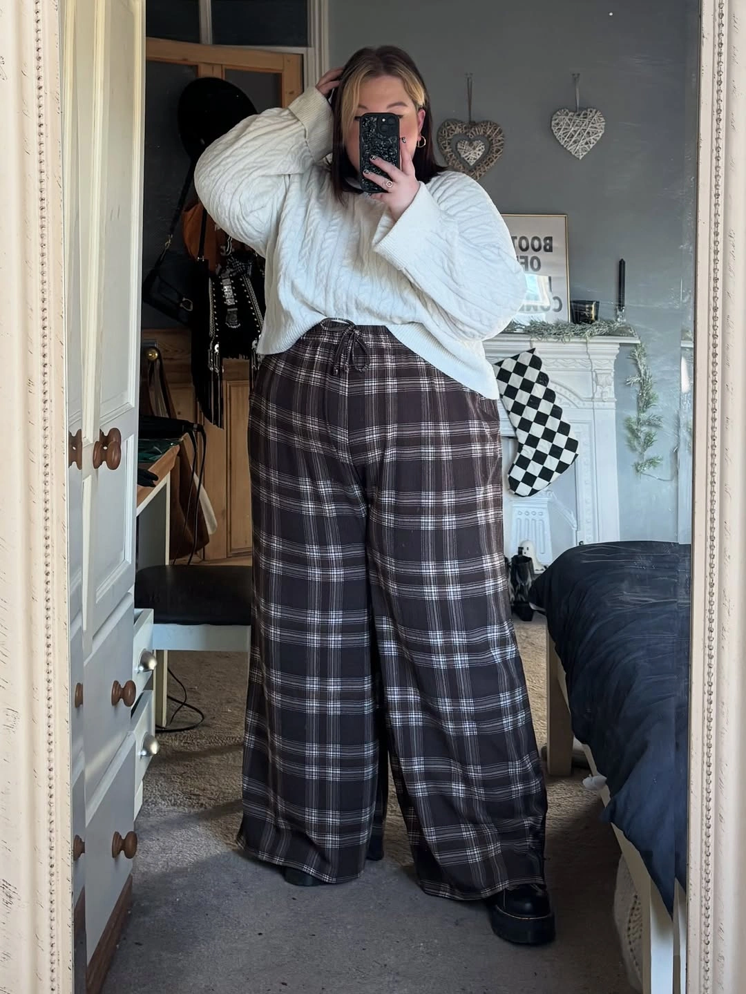 Cream knit top with wide dark plaid trousers