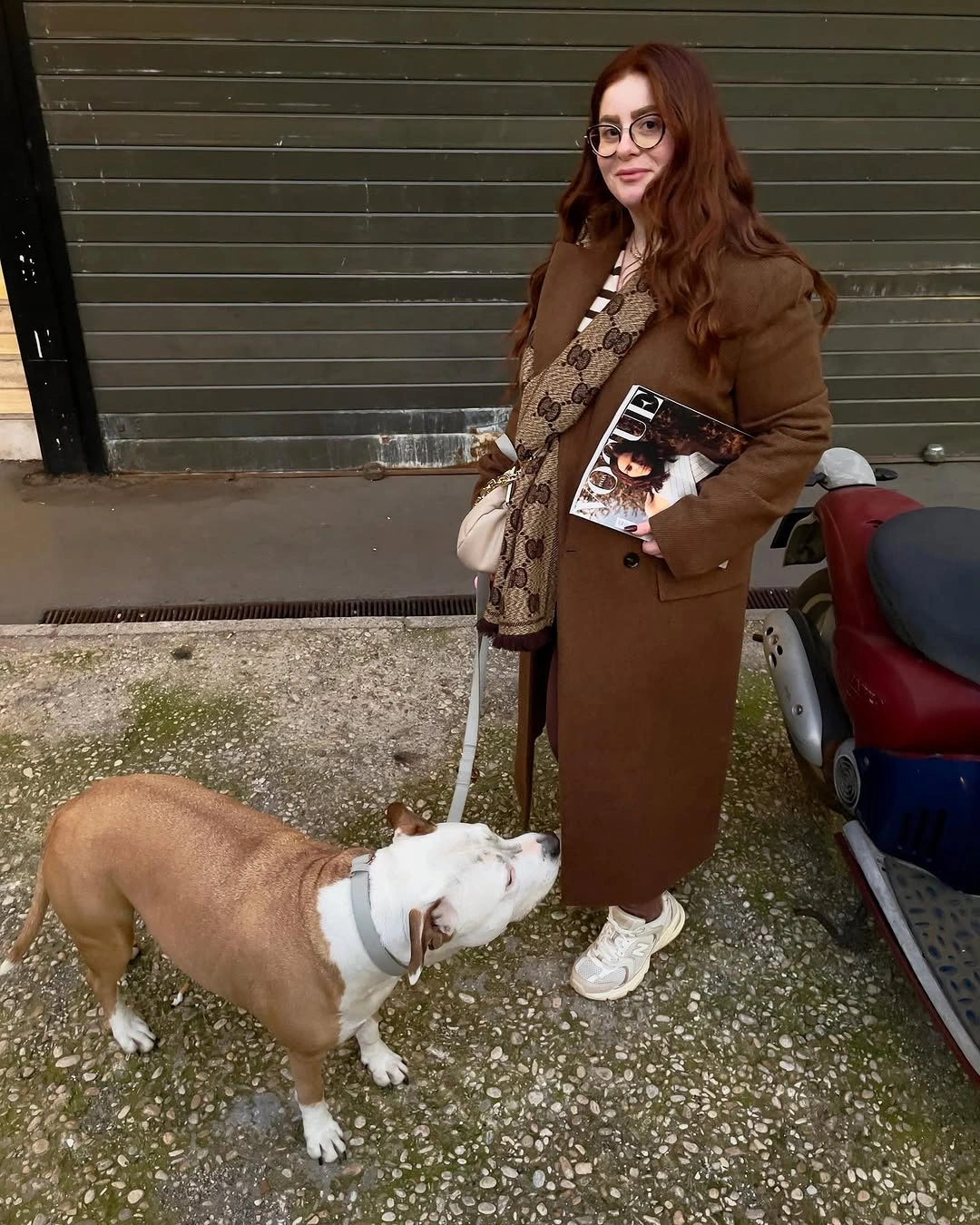 Long brown coat with patterned middle layer and cream bag