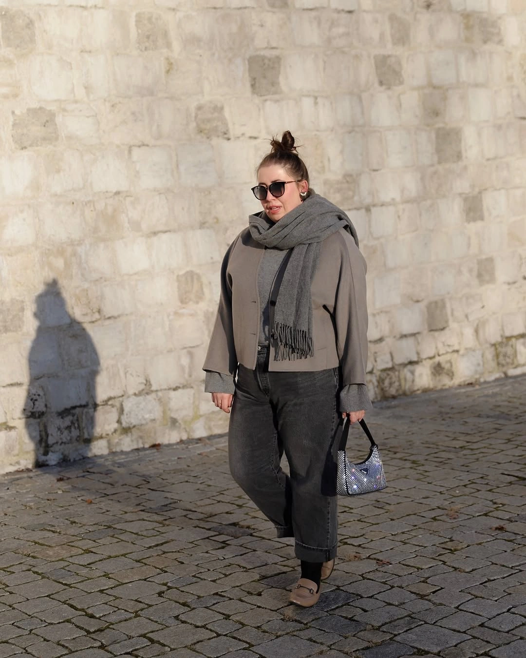 Gray short jacket, scarf, cuffed dark jeans, taupe boots