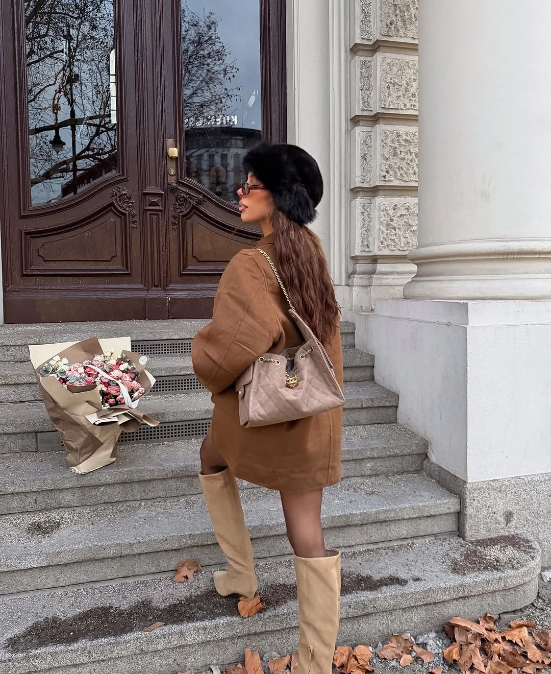 Dark oversized jacket with rust lining and tall gray boots
