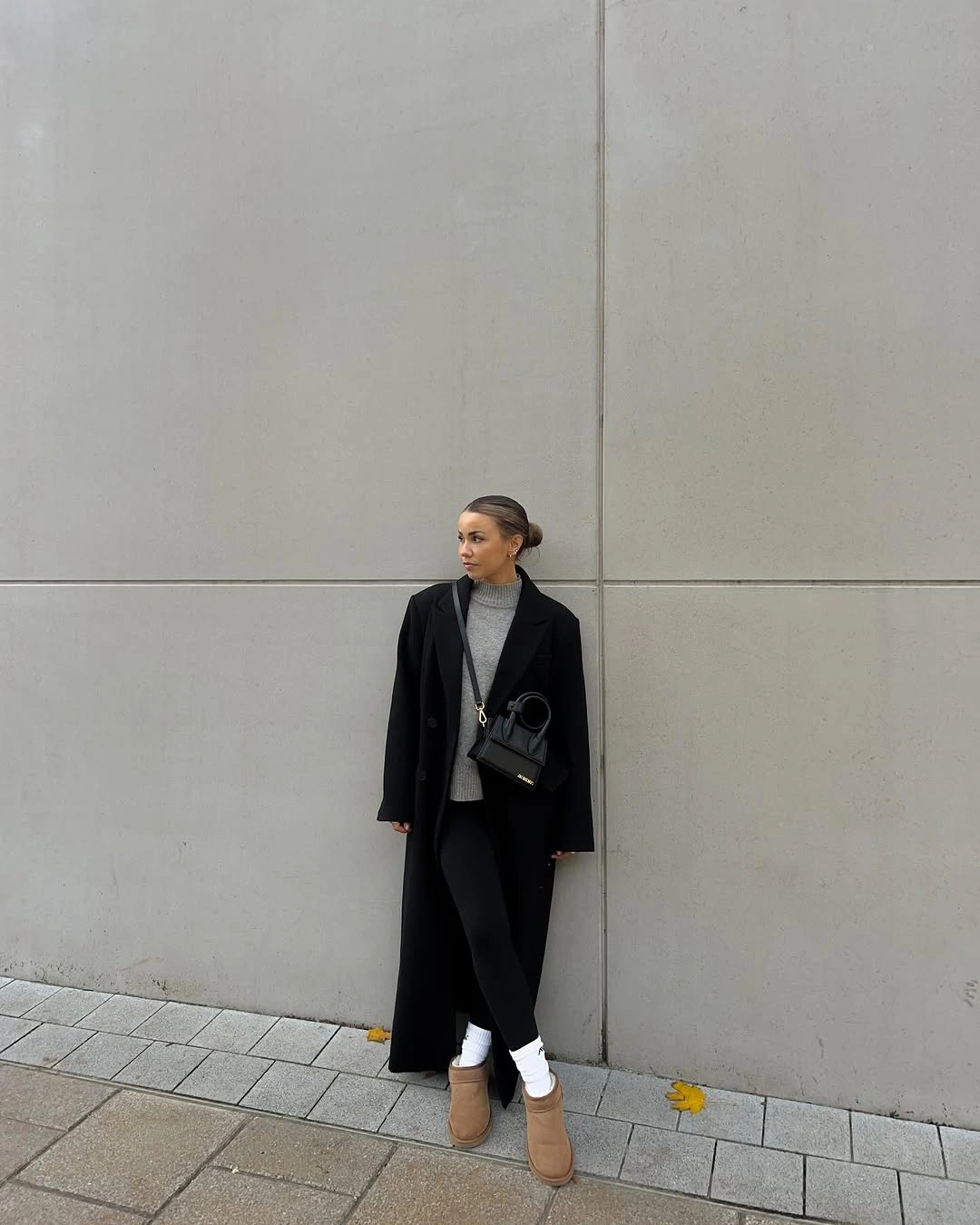 Cream fuzzy-looking jacket with light jeans and animal-print bag