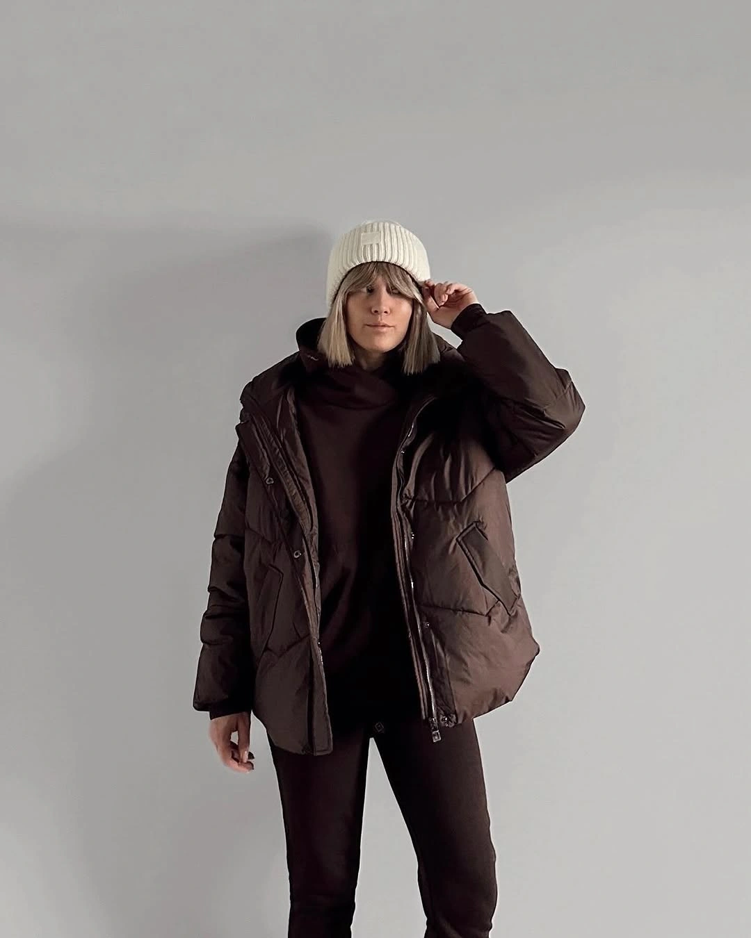 Chocolate brown puffer with black layers and cream ribbed beanie