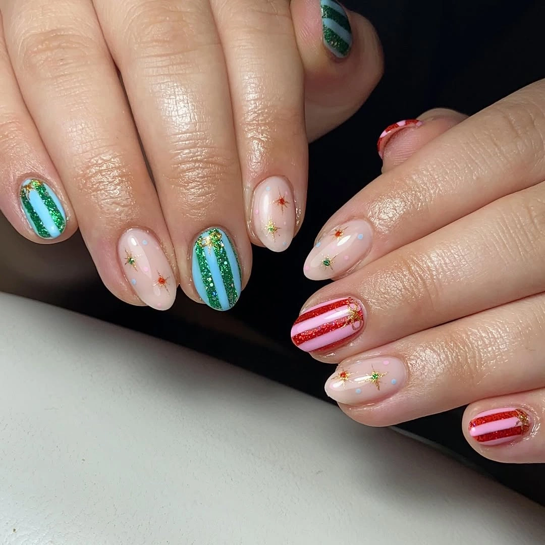 Short rounded nails with red and green stripes and tiny stars