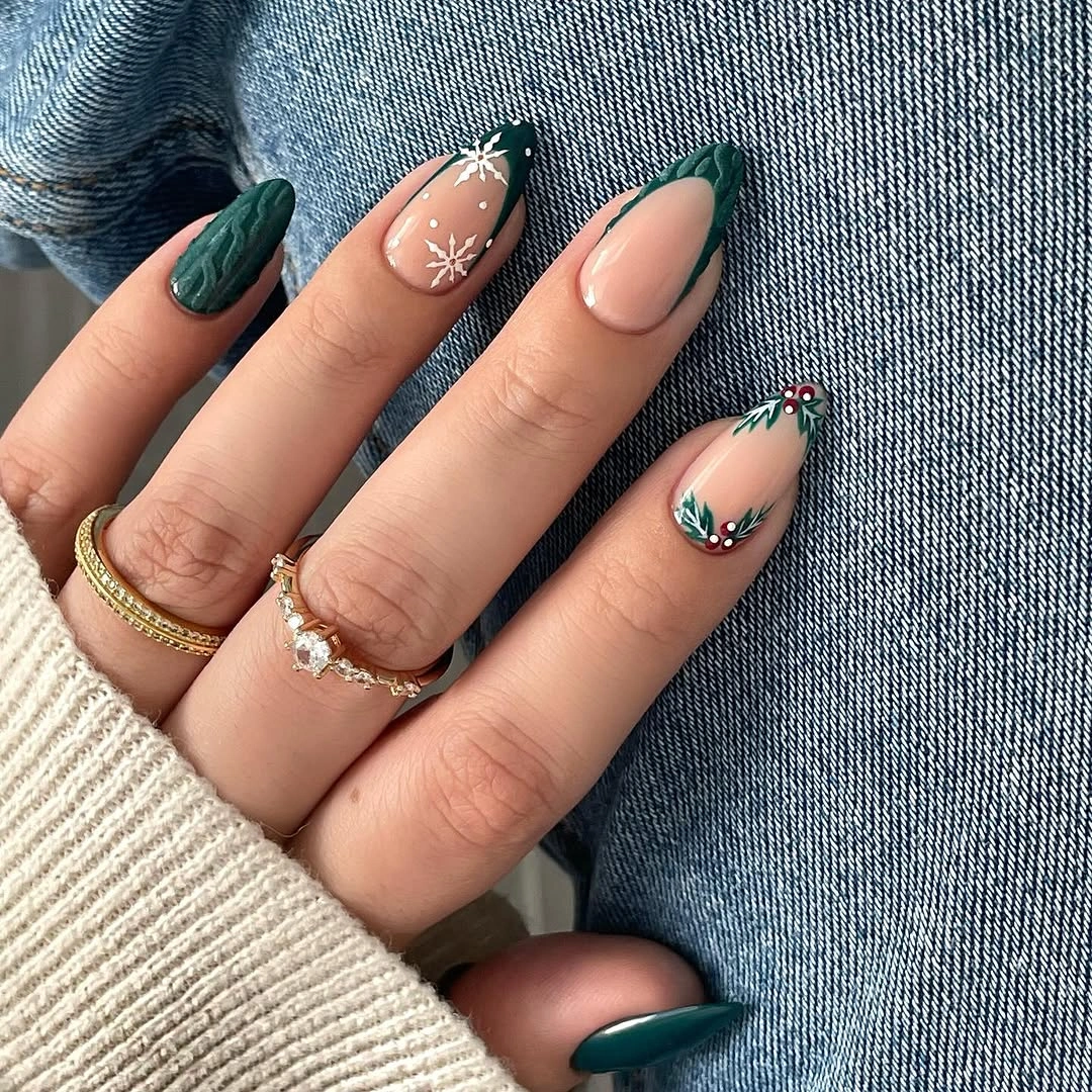Almond green nails with nude bases, snowflakes, and leafy accents