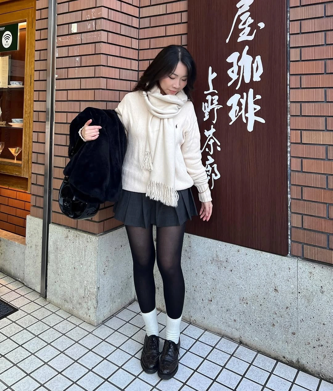 Cream scarf and sweater with black pleated mini skirt