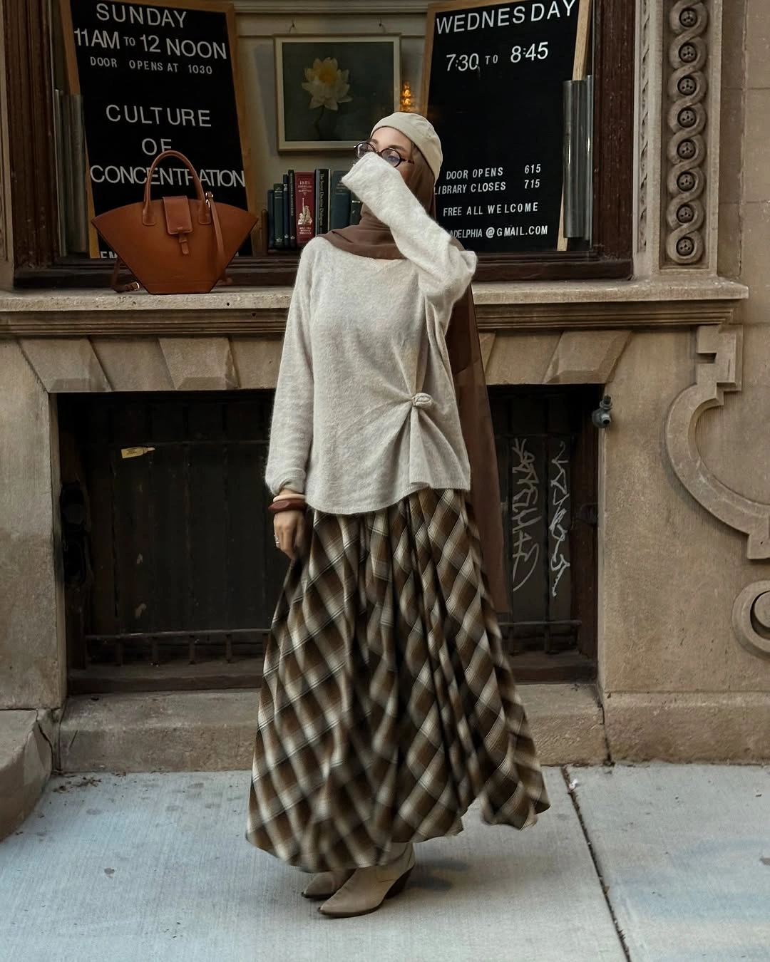 Light sweater with plaid long skirt, headscarf, and beige boots