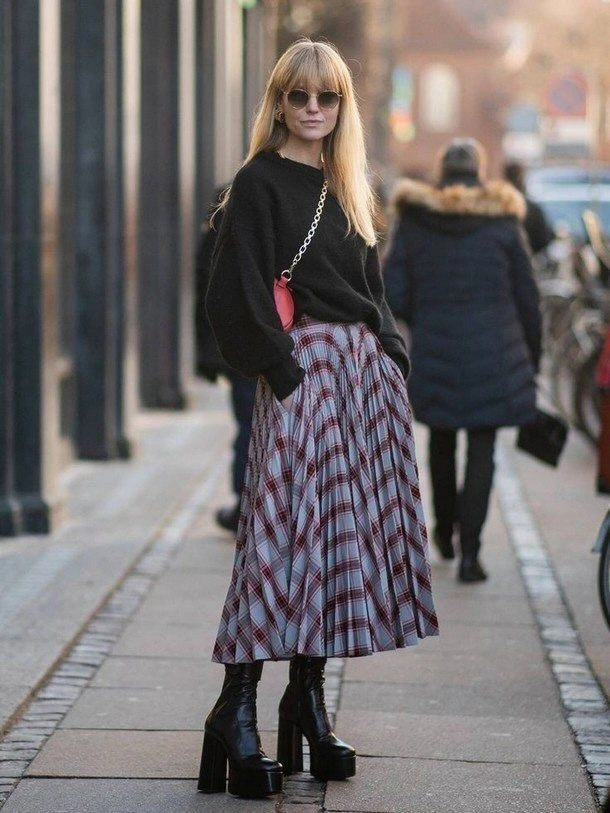 Black sweater with plaid pleated skirt and platform boots
