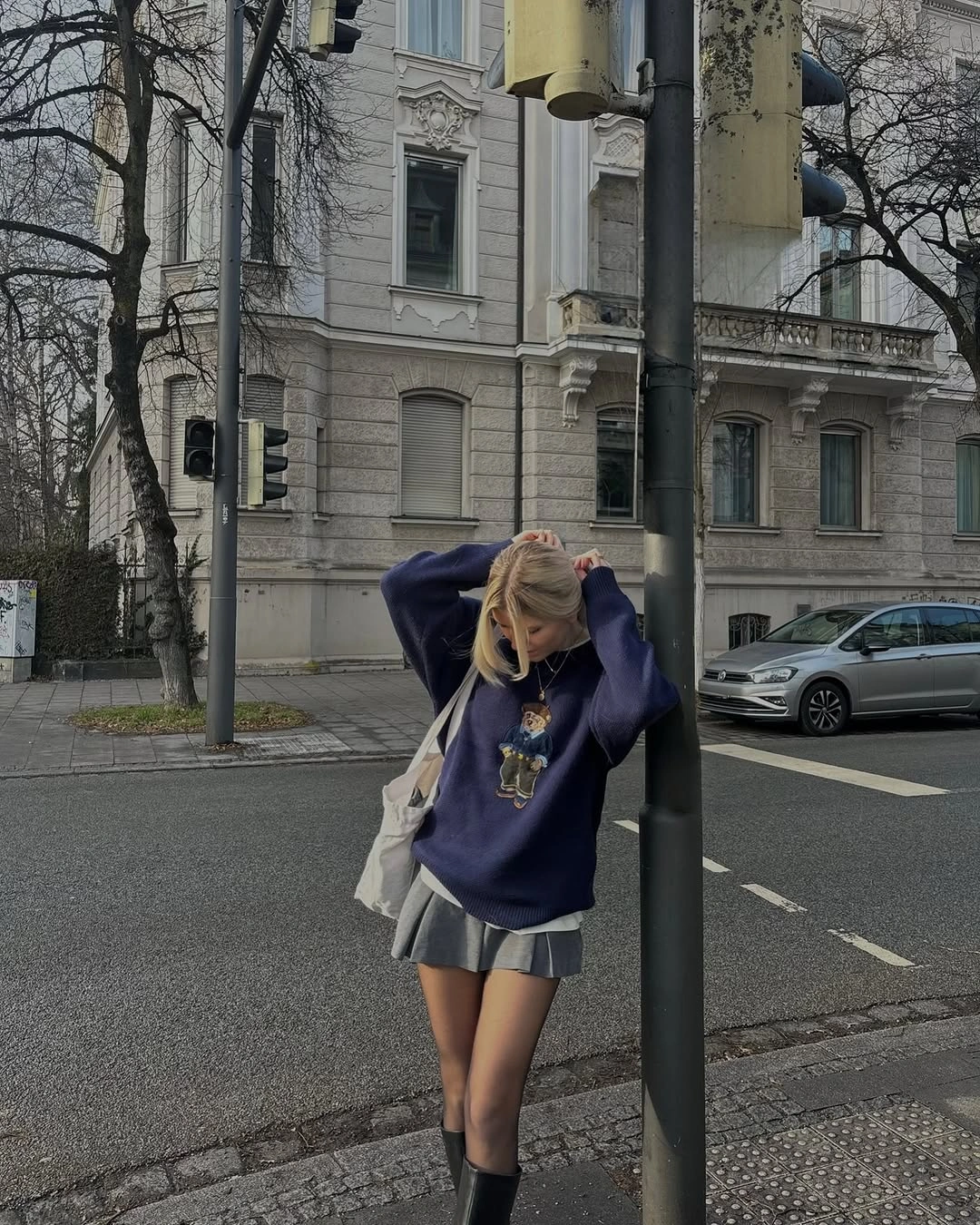 Oversized blue graphic sweatshirt with gray pleated mini skirt