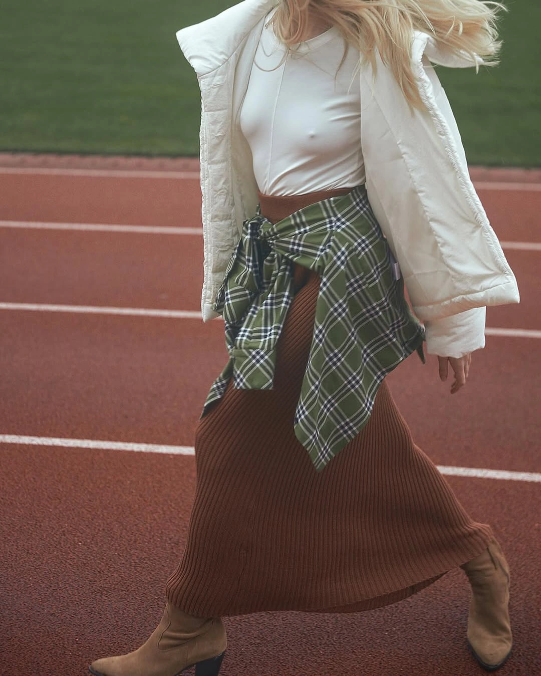 White puffer-style jacket with plaid shirt and ribbed skirt