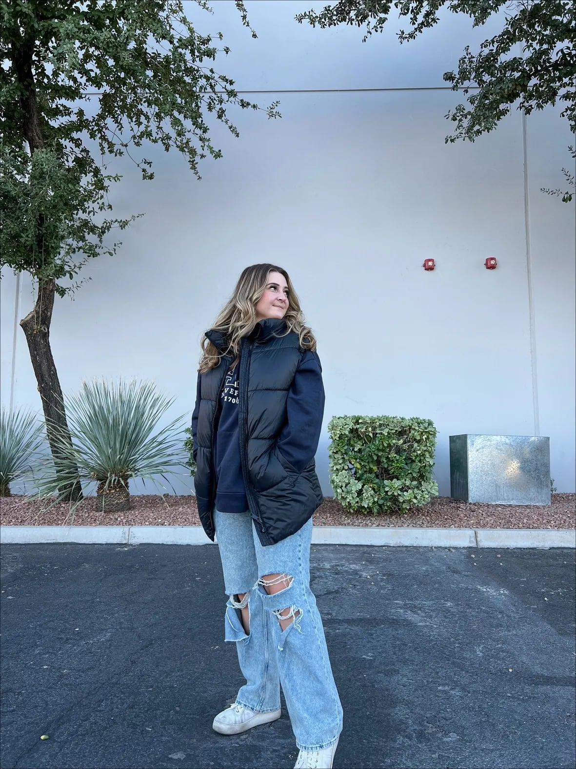 Navy Hoodie Layered Under Black Puffer Vest With Ripped Baggy Jeans Navy Hoodie Layered Under Black Puffer Vest With Ripped Baggy Jeans — Aesthetic Hoodie Outfits Women