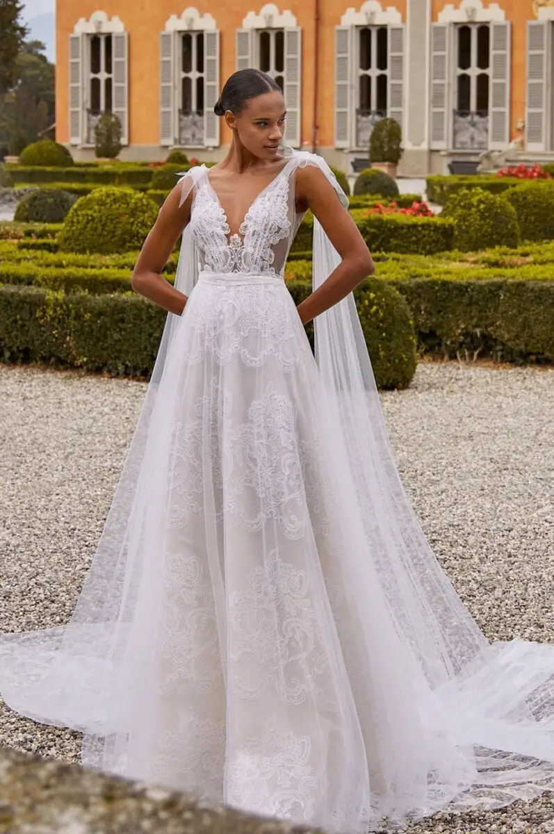 Ivory A-Line Wedding Dress with Plunging Neckline and Sheer Cape Ivory A-Line Wedding Dress with Plunging Neckline and Sheer Cape — Aesthetic Wedding Dress