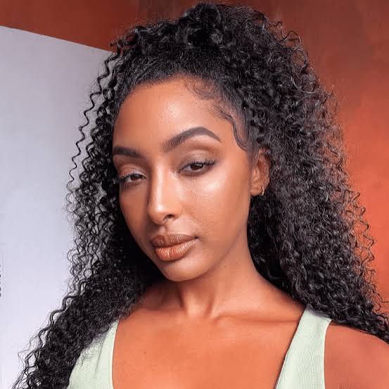 Mid-Back Black Curly Hair With Curtain Bangs — Classy Black Curly Hair