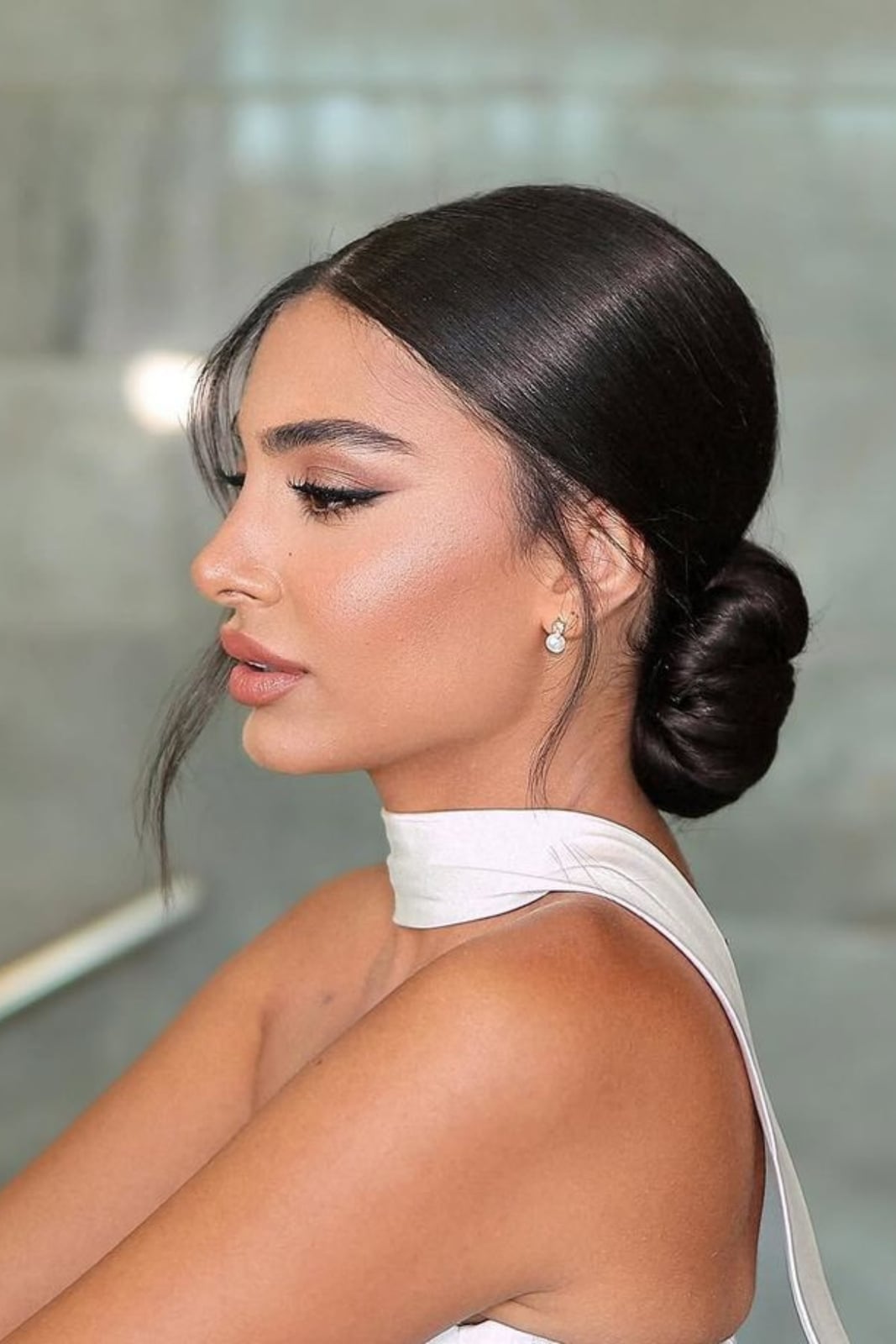 Fine Dark Brown Sleek Low Bun With Wispy Face-Framing Fine Dark Brown Sleek Low Bun With Wispy Face-Framing — Classy Bridesmaid Hair
