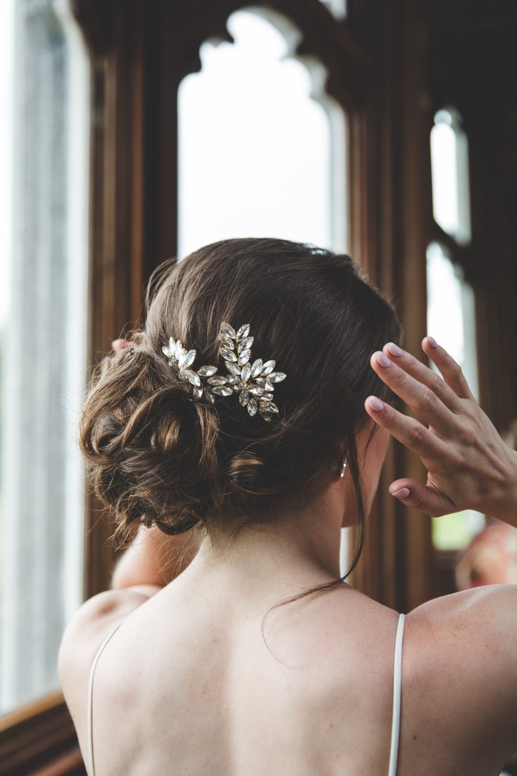 Dark Brown Messy Bun With Leaf Accessory — Classy Bridesmaid Hair Updo