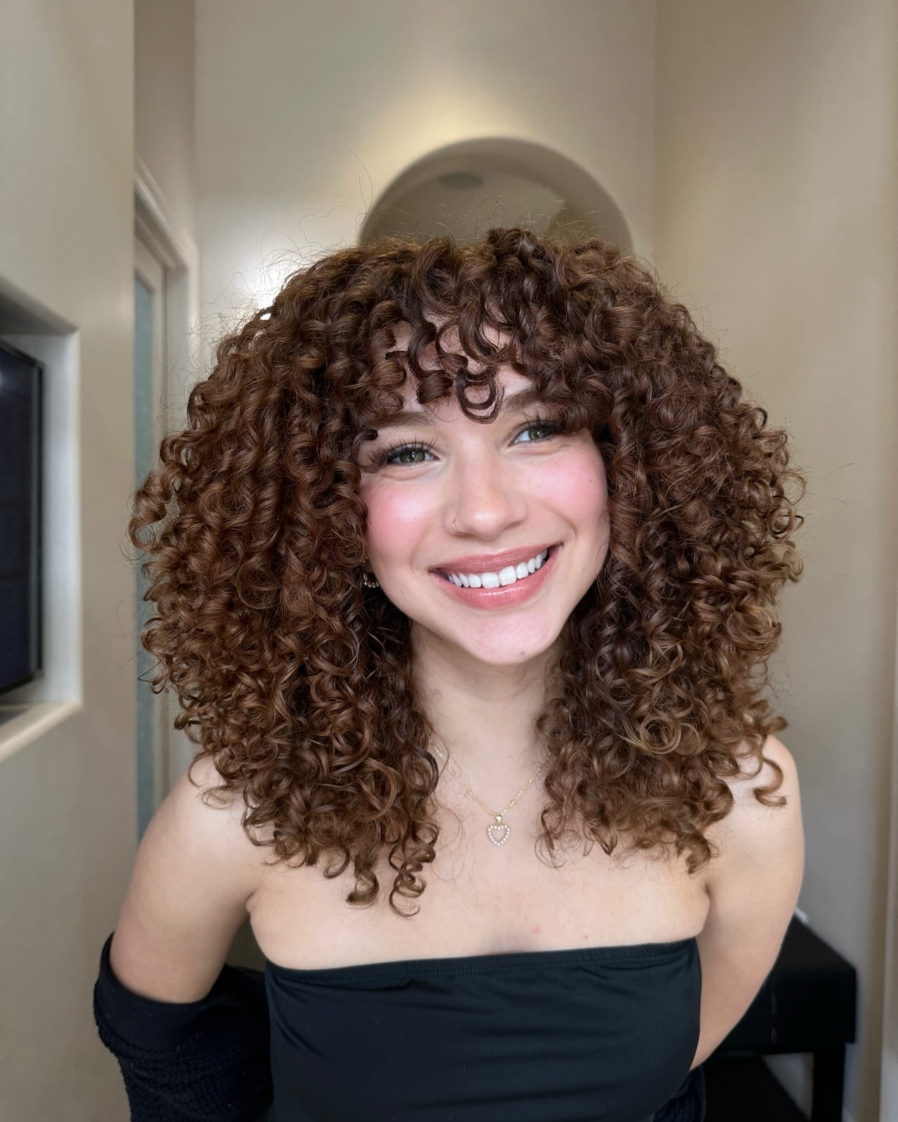 Mid-Back Curly Layers With Caramel Highlights and Full Bangs Mid-Back Curly Layers With Caramel Highlights and Full Bangs — Classy Brown Curly Hair