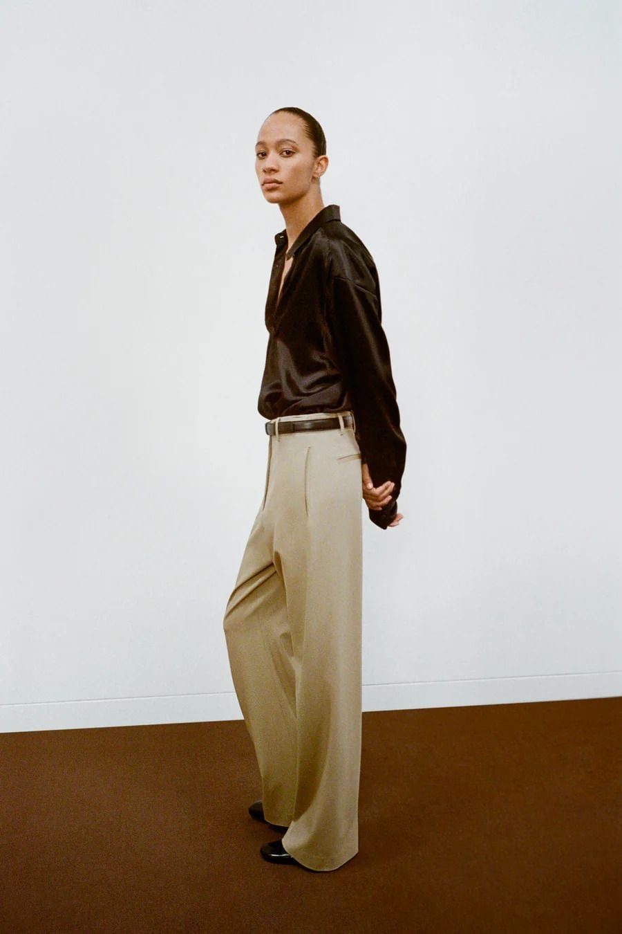 Black Silk Shirt Offers Elegant Simplicity with Beige Trousers Black Silk Shirt Offers Elegant Simplicity with Beige Trousers — Classy Capsule Wardrobe