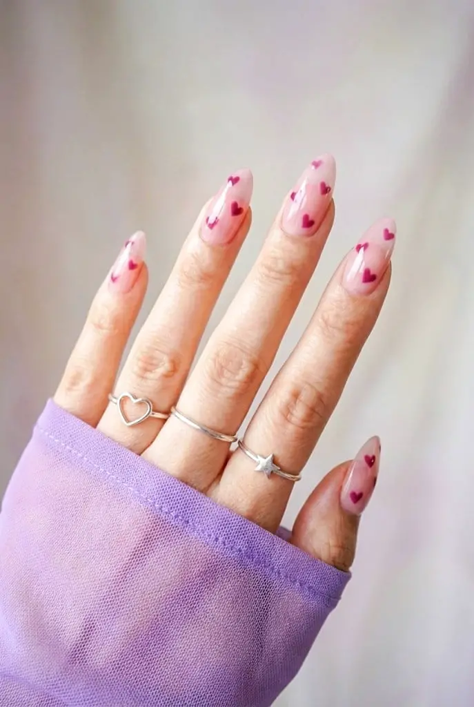 Sheer Pink With Scattered Red Hearts Long Almond Nails Sheer Pink With Scattered Red Hearts Long Almond Nails — Classy Concert Nails
