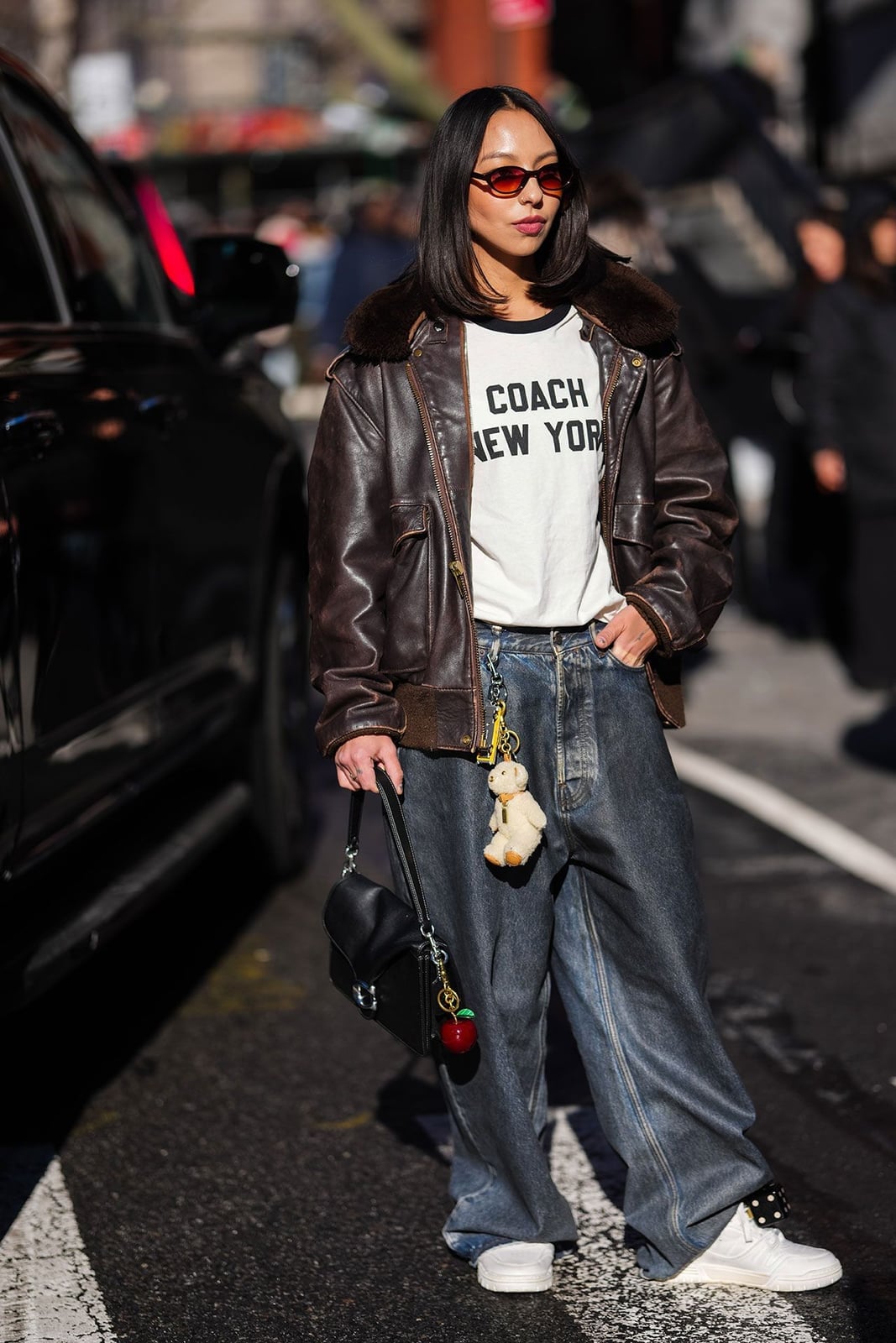 Brown Leather Bomber Jacket With Wide-Leg Jeans and White Sneakers Brown Leather Bomber Jacket With Wide-Leg Jeans and White Sneakers — Classy Concert Outfits