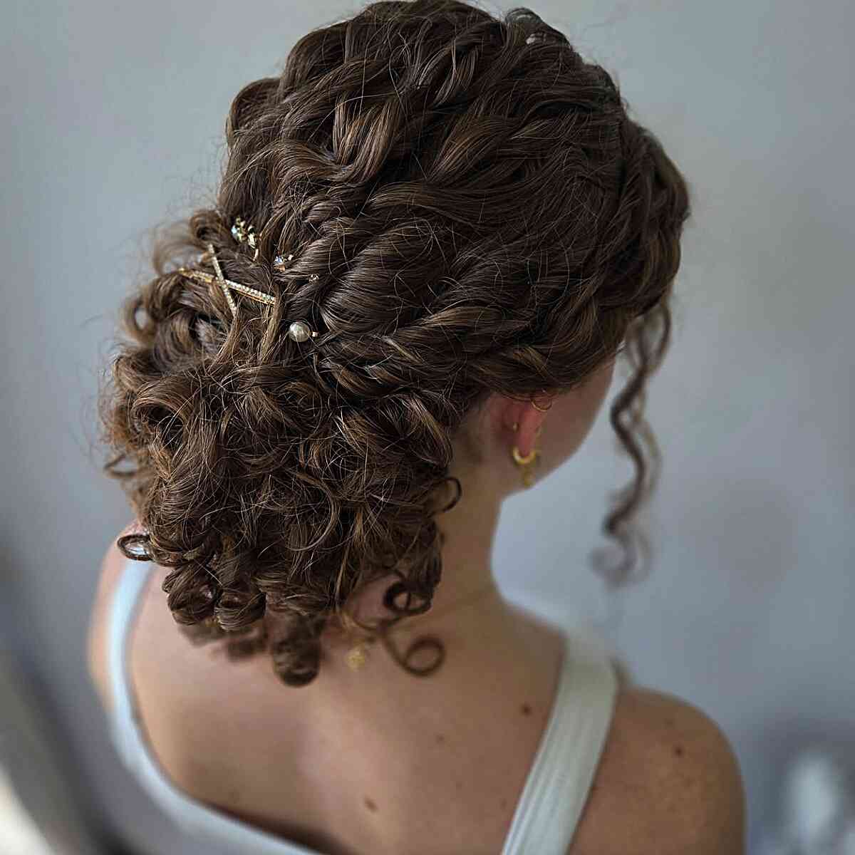 Dark Brown Curly Updo With Floral Accessory Dark Brown Curly Updo With Floral Accessory — Classy Curly Hair Hairstyles