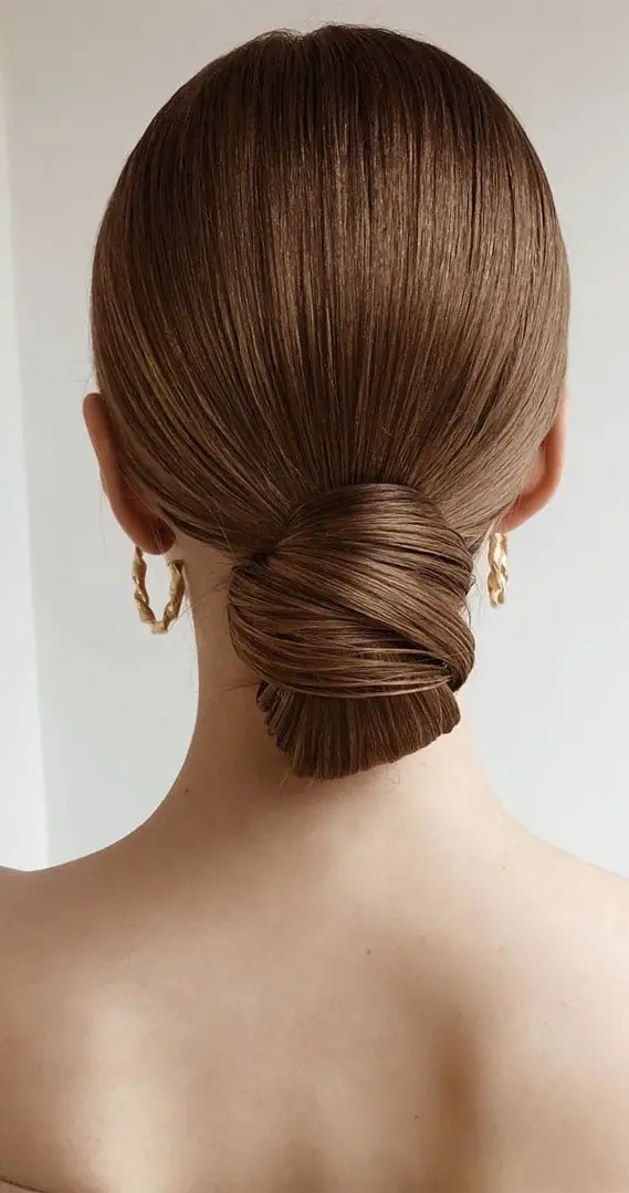 Sleek Medium Brown Low Bun Wet Look — Classy Going Out Hairstyles