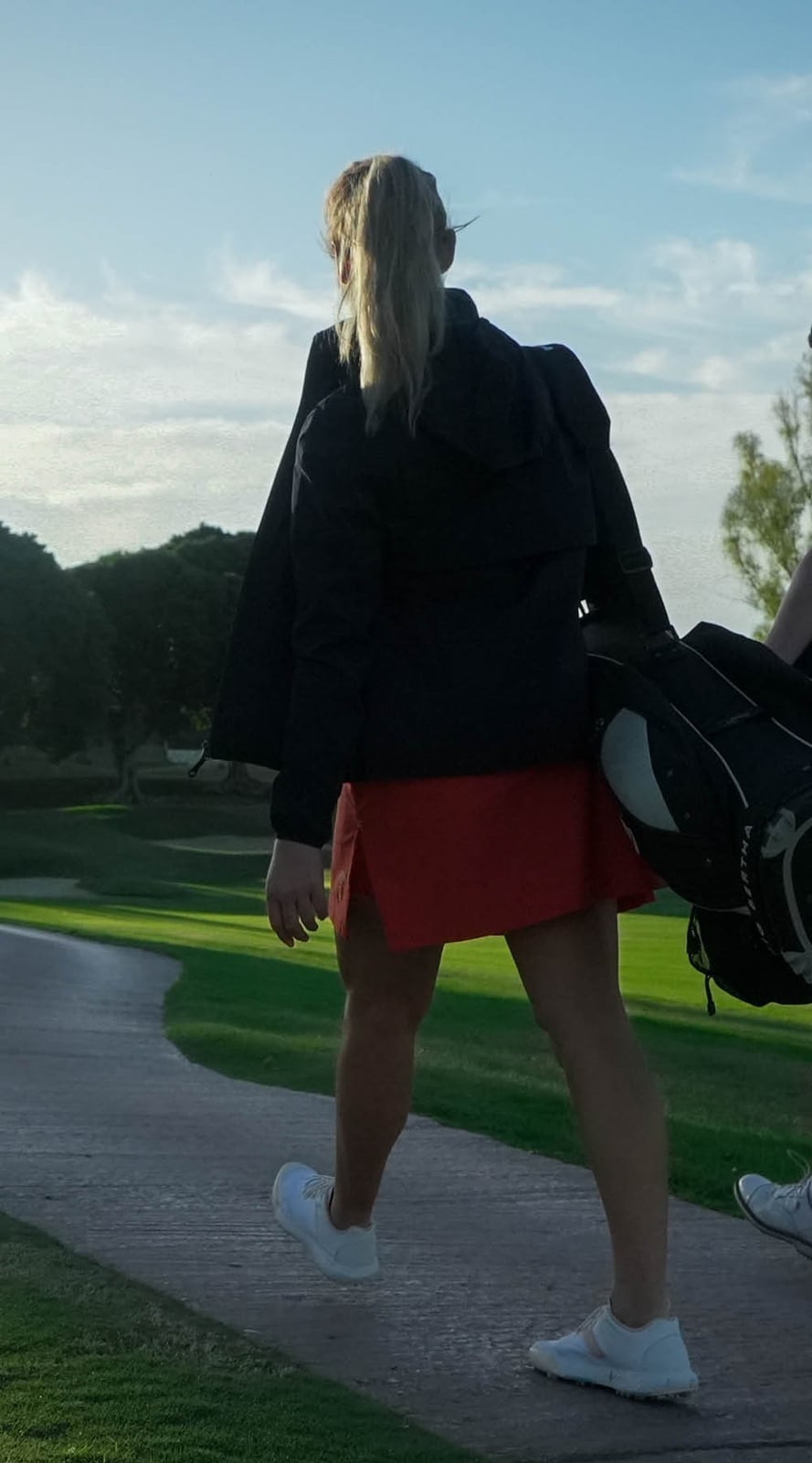 Red Skort and Dark Hooded Jacket — Classy Golf Outfits