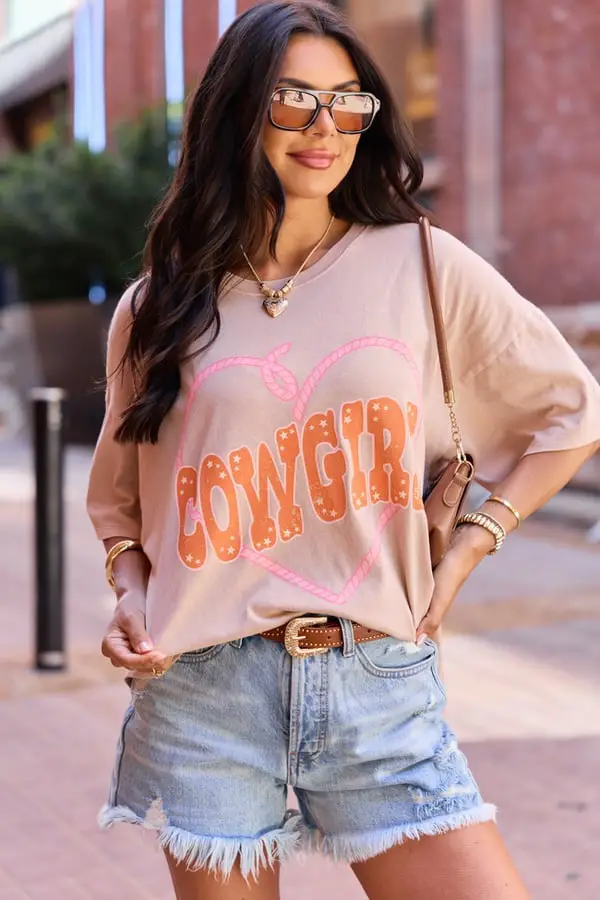 Beige Oversized Graphic Tee with 'Cowgirl' Print and Denim Shorts Beige Oversized Graphic Tee with 'Cowgirl' Print and Denim Shorts — Classy Graphic Tee Outfits