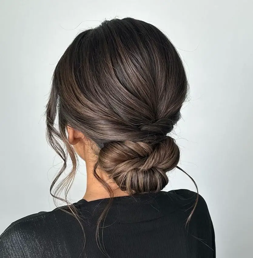 Dark Brown Twisted Low Bun With Tendrils Dark Brown Twisted Low Bun With Tendrils — Classy Hairstyles to Do
