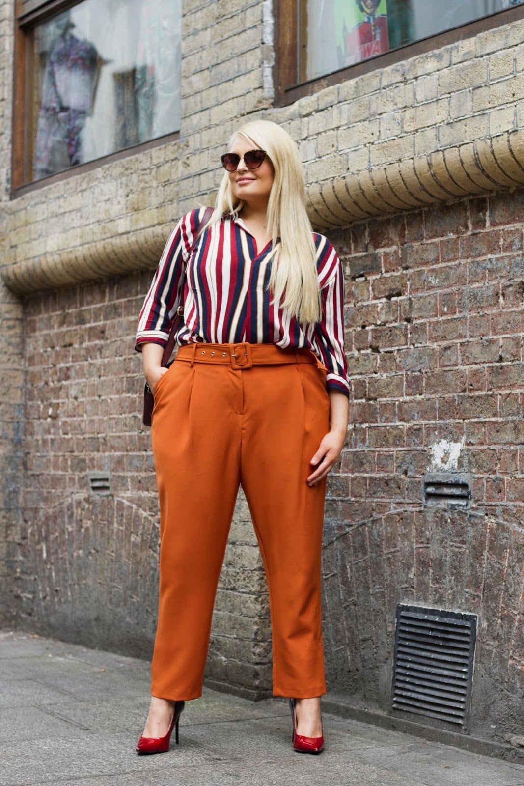Burnt Orange Pleated Trousers with Striped Blouse and Red Heels — Classy Orange Pants Outfits