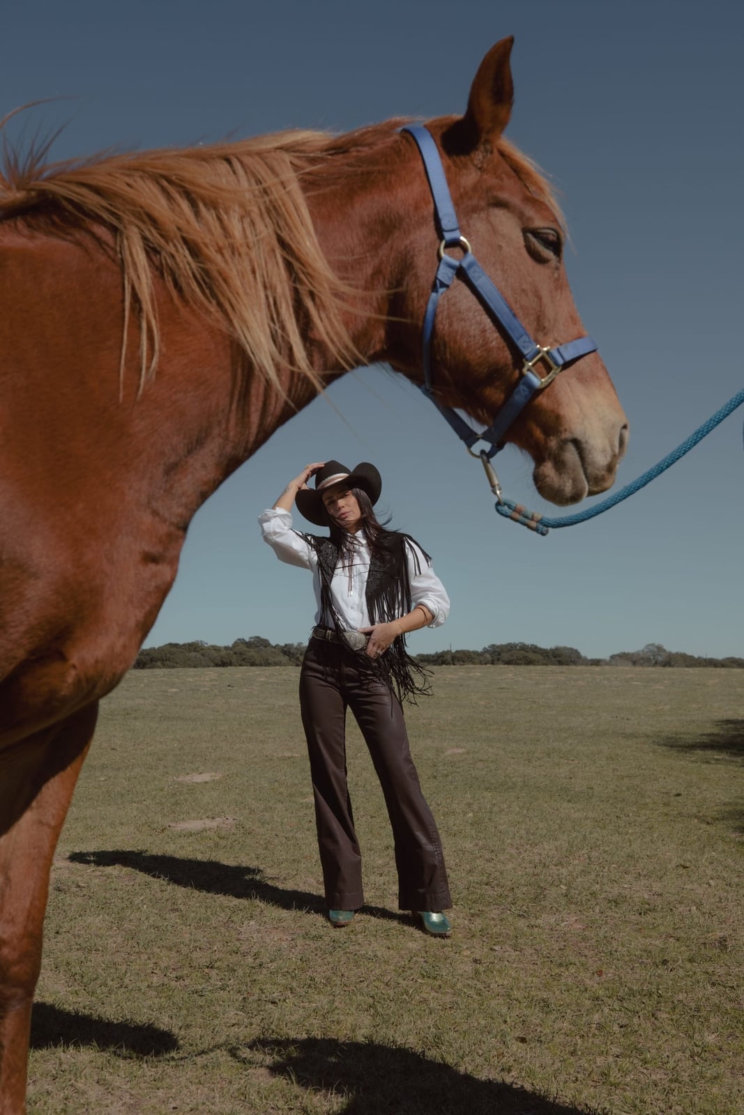 Fringed Vest Over Button-Down Shirt With Metallic Green Pointed Boots — Classy Rodeo Outfits for Women