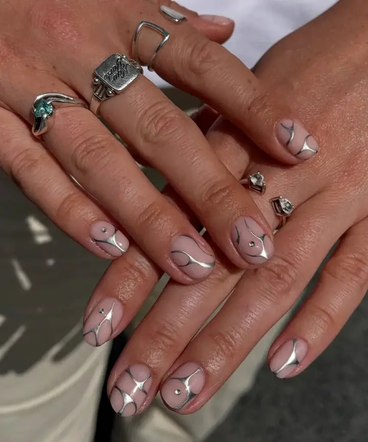 Short Almond Nude Base With Silver Line Art And Rhinestones Short Almond Nude Base With Silver Line Art And Rhinestones — Classy Silver Chrome Nails