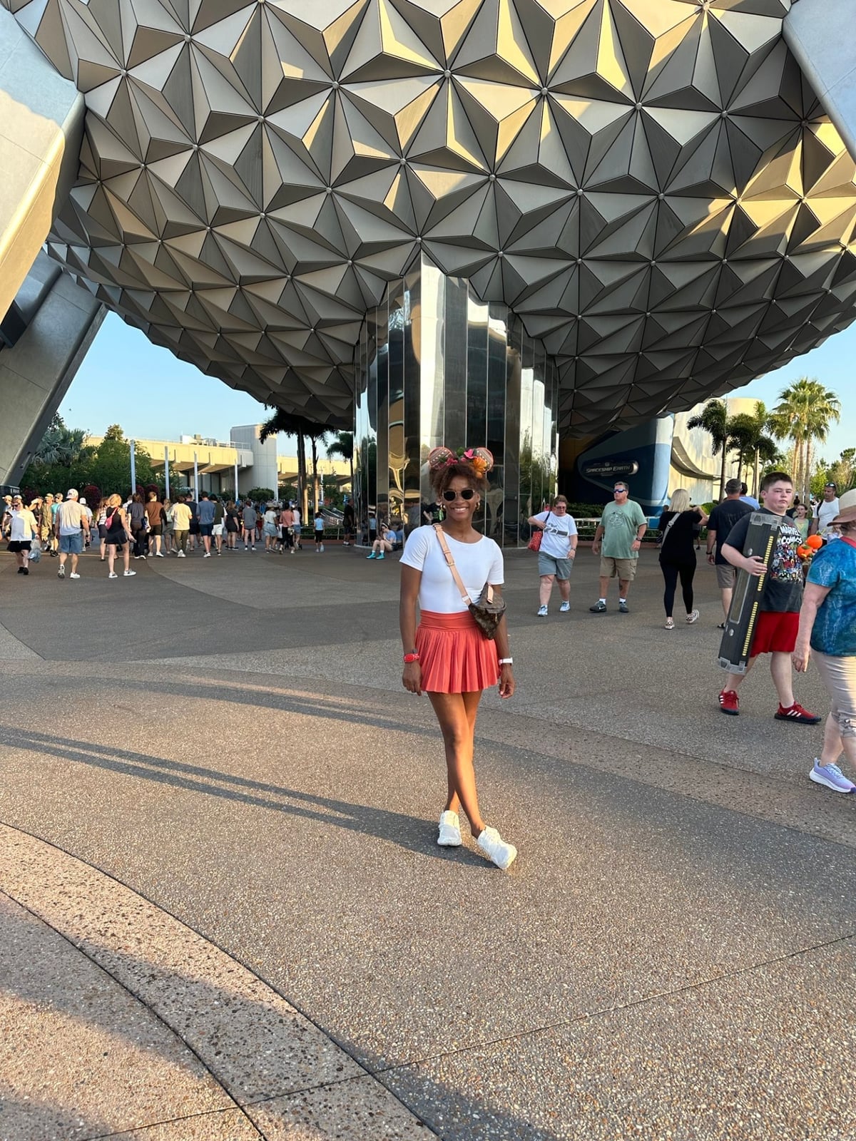 Coral Pleated Skirt and White Tee Theme Park Outfit Coral Pleated Skirt and White Tee Theme Park Outfit — Classy Theme Park Outfits