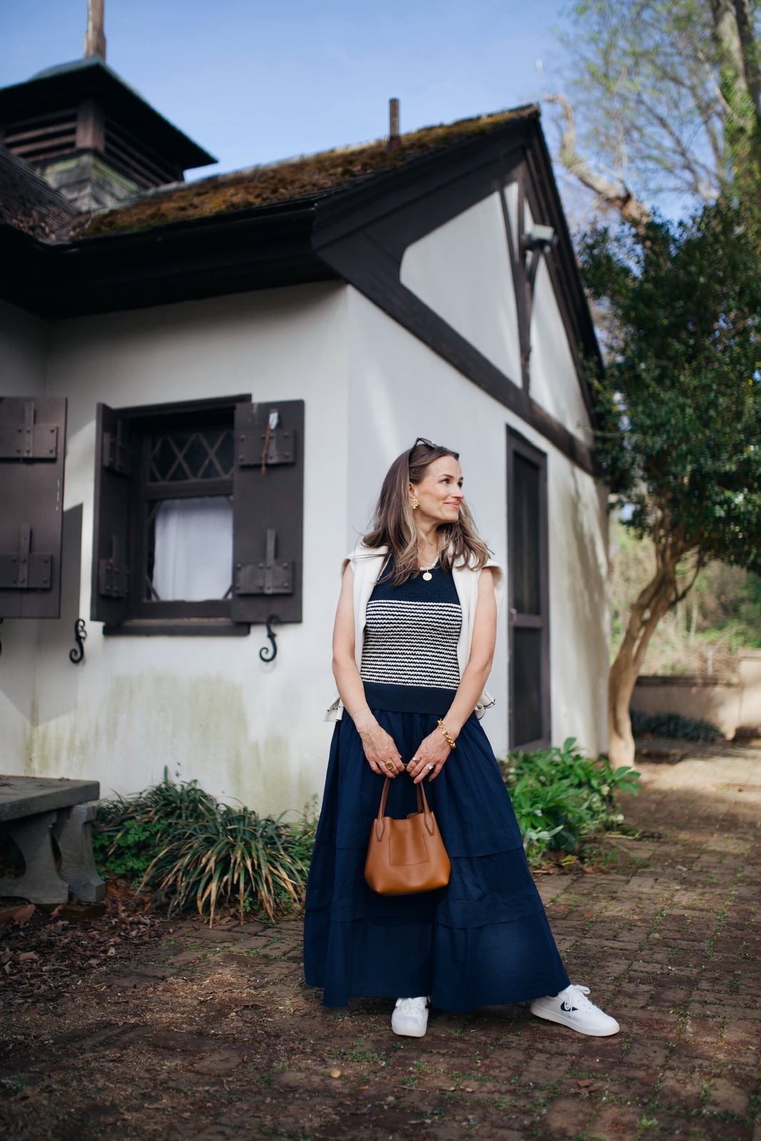 Navy Tiered Midi Skirt with Striped Top and Vest — Classy Travel Outfits