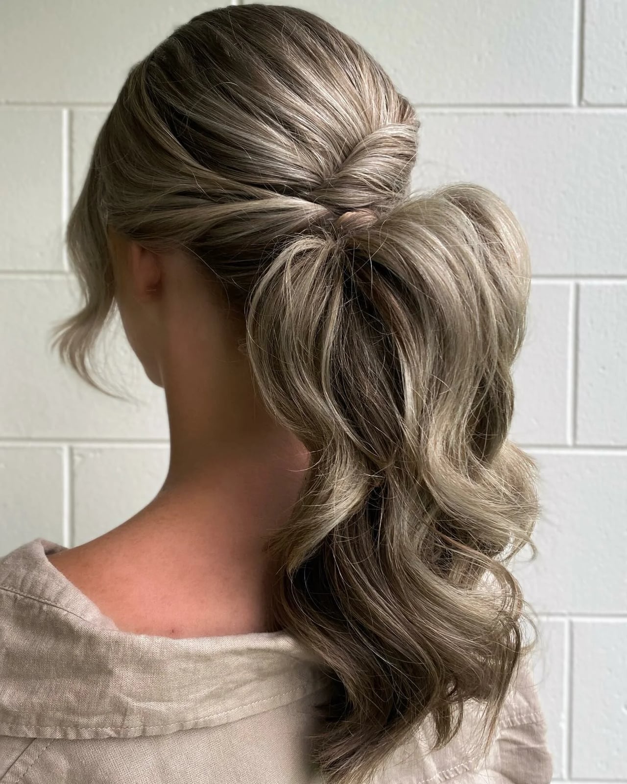 Ash Blonde Low Ponytail With Waves Ash Blonde Low Ponytail With Waves — Classy Work Hair