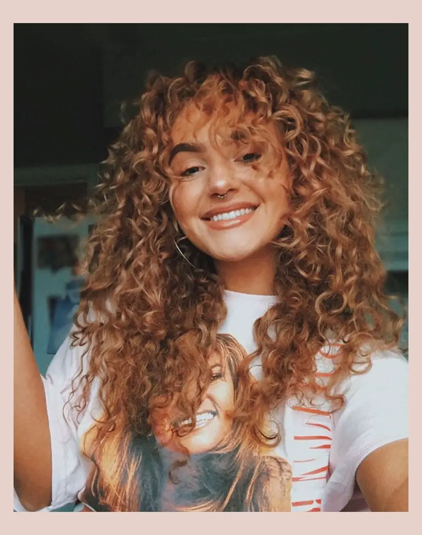Mid-Back Caramel Blonde With Wispy Bangs — Curly Hair Dye Inspiration
