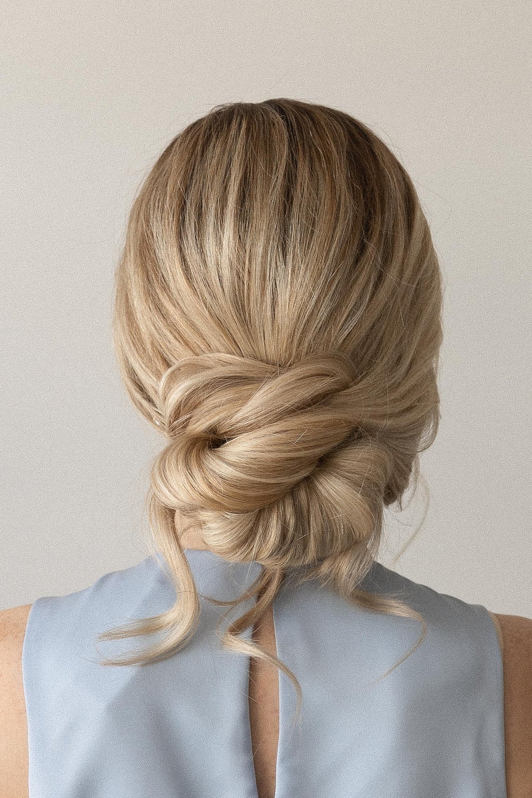 Neat Low Twisted Bun With Face-Framing Tendrils Neat Low Twisted Bun With Face-Framing Tendrils — Simple Bridesmaid Updos