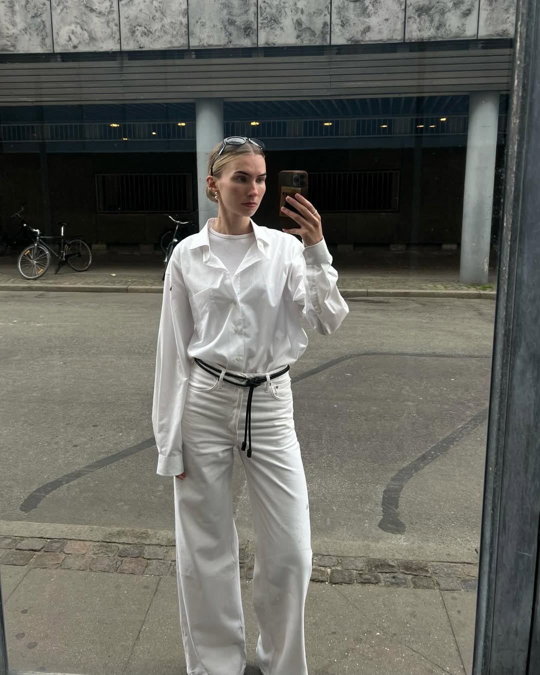 Oversized White Shirt with Wide-Leg Blue Jeans and Sneakers Oversized White Shirt with Wide-Leg Blue Jeans and Sneakers — Simple Button Down Outfits