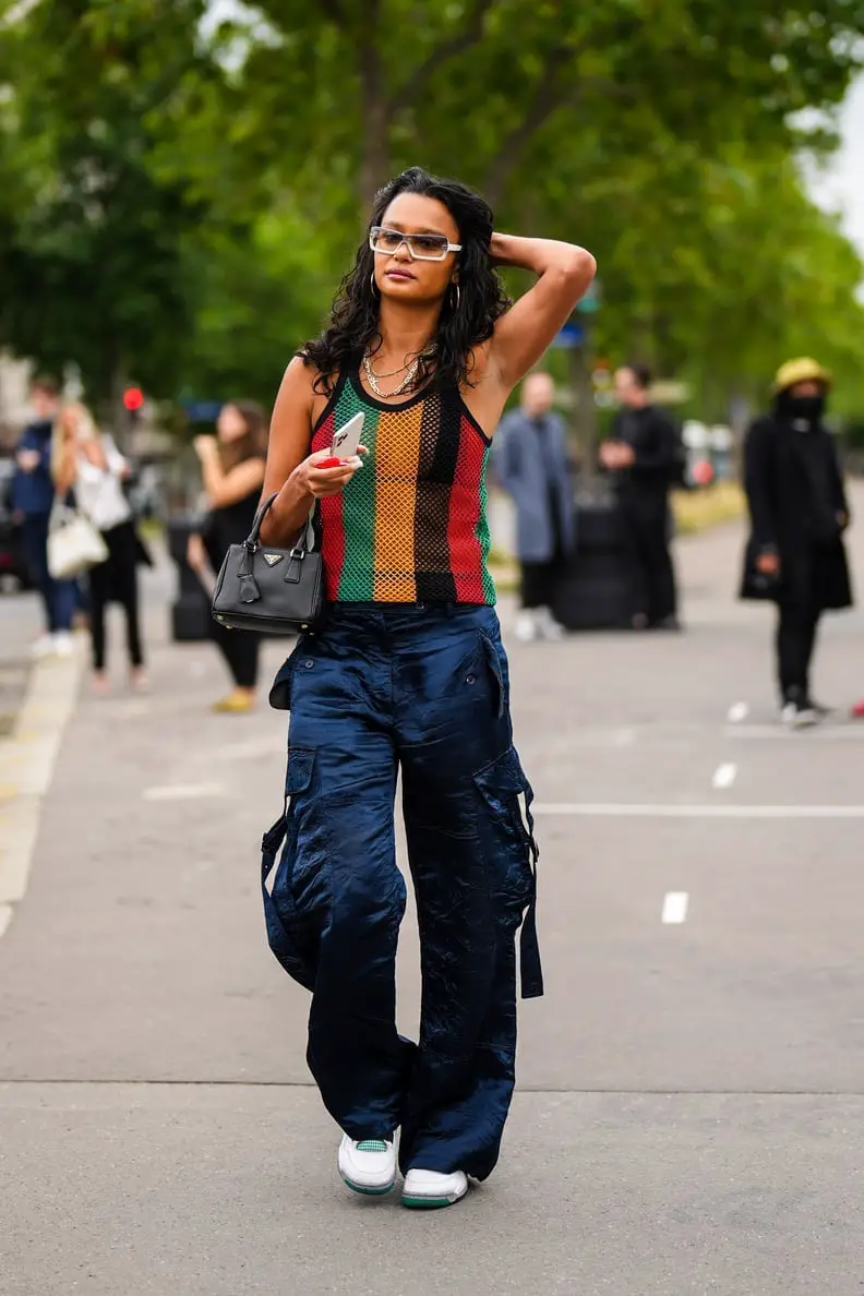 Navy Shiny Cargo Pants With Striped Tank Top and Wears White Sneakers — Simple Cargo Pants Outfits