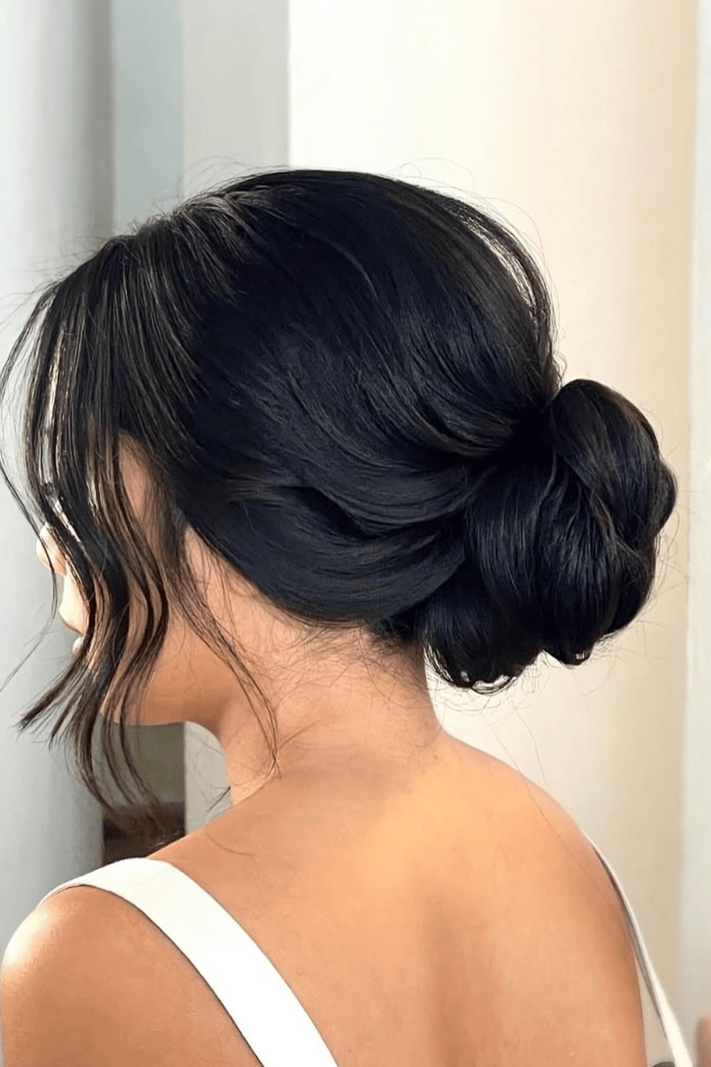 Low Bun With Effortless Dark Brown Tendrils Low Bun With Effortless Dark Brown Tendrils — Simple Casual Updo