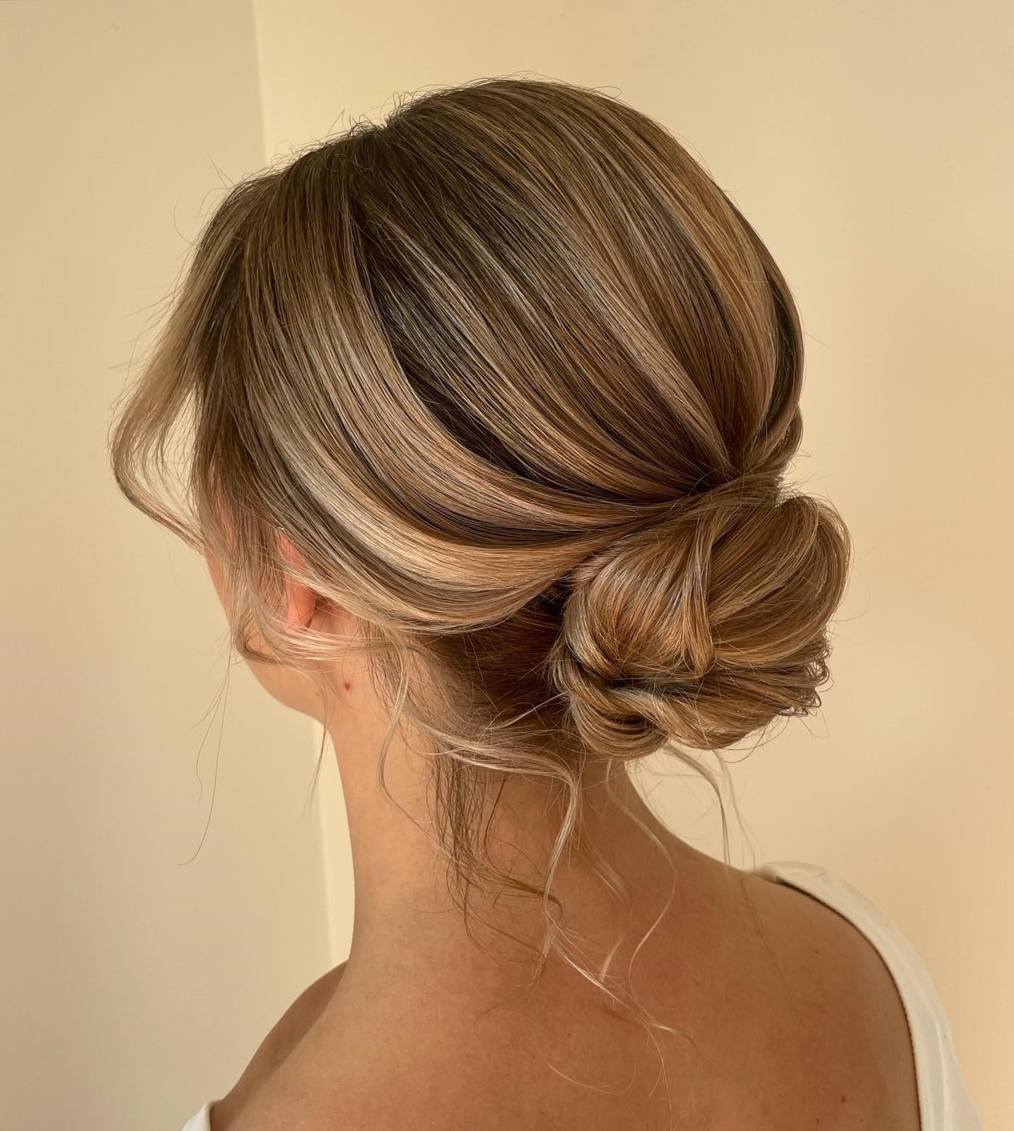 Textured Low Bun With Twisted Blonde Balayage, Close-Up Take Textured Low Bun With Twisted Blonde Balayage, Close-Up Take — Simple Casual Updo