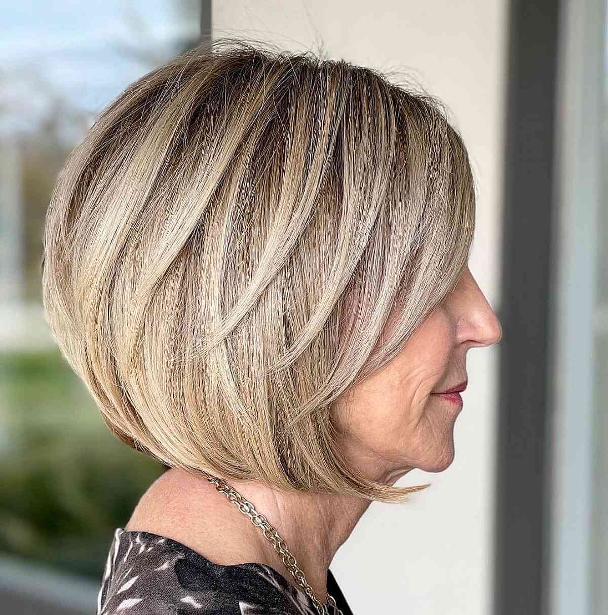 Layered Blonde Bob With Stacked Layers and Side-Swept Bangs Layered Blonde Bob With Stacked Layers and Side-Swept Bangs — Simple Chin Length Bob