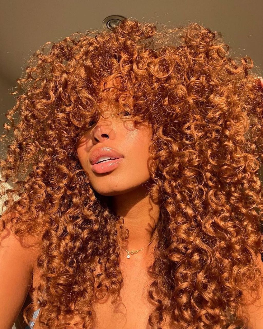 Vibrant Ginger Coils With Full Fringe Vibrant Ginger Coils With Full Fringe — Simple Cinnamon Hair Color