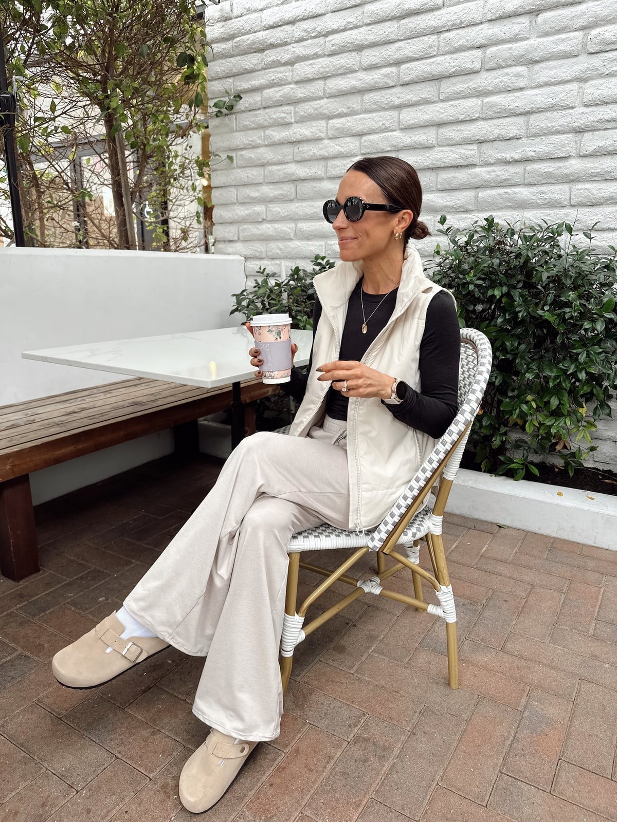 Cream Puffer Vest Over Flared Trousers with Suede Clogs Cream Puffer Vest Over Flared Trousers with Suede Clogs — Simple Clogs Outfits