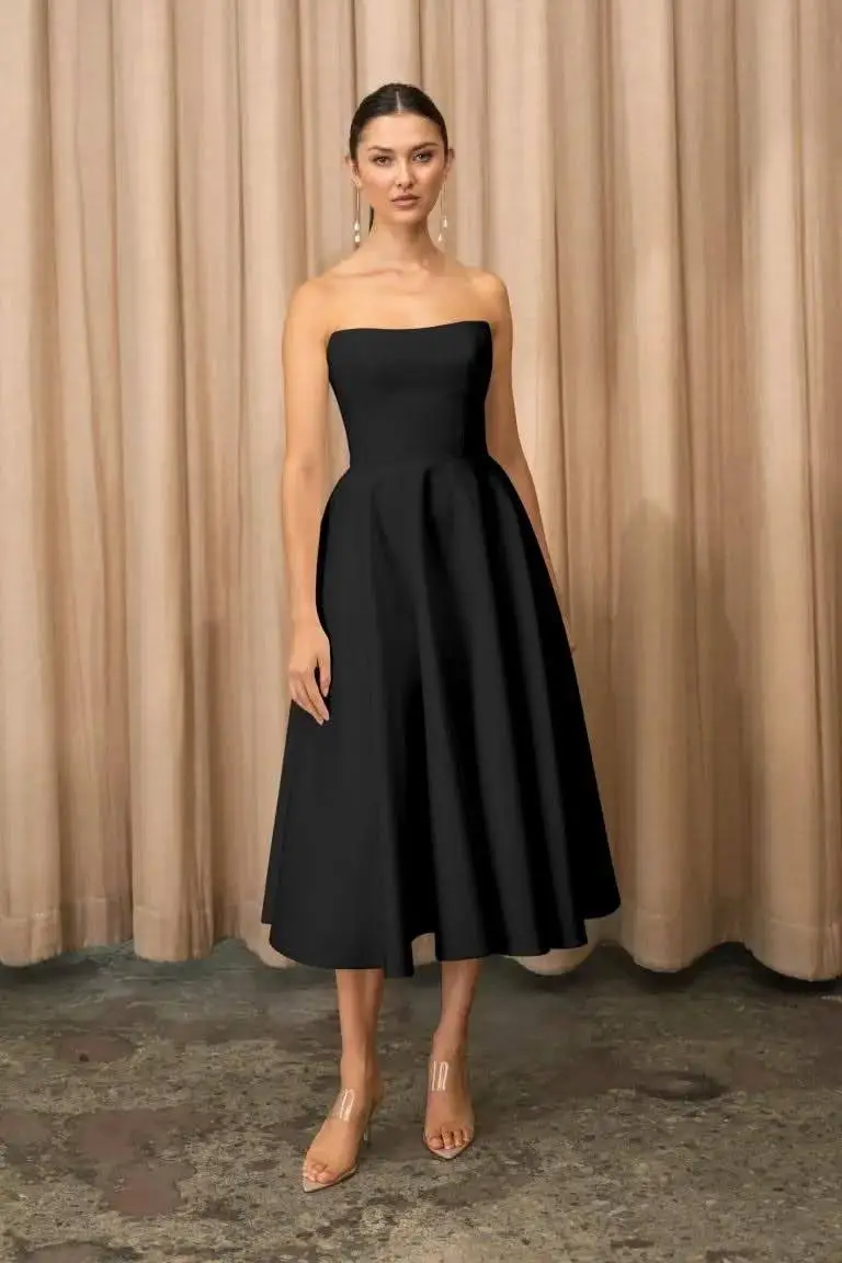 Black Strapless Midi Dress with Structured A-line Skirt, Close-Up Take Black Strapless Midi Dress with Structured A-line Skirt, Close-Up Take — Simple Cocktail Dresses Wedding Guest
