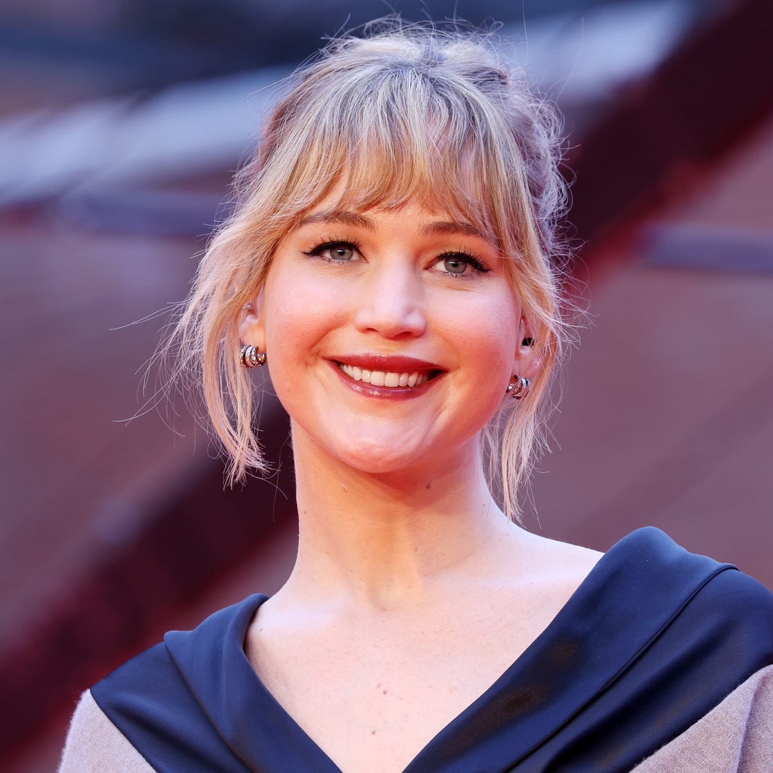 Long Wavy Blonde With Messy Bun and Wispy Bangs — Simple Cut Bangs