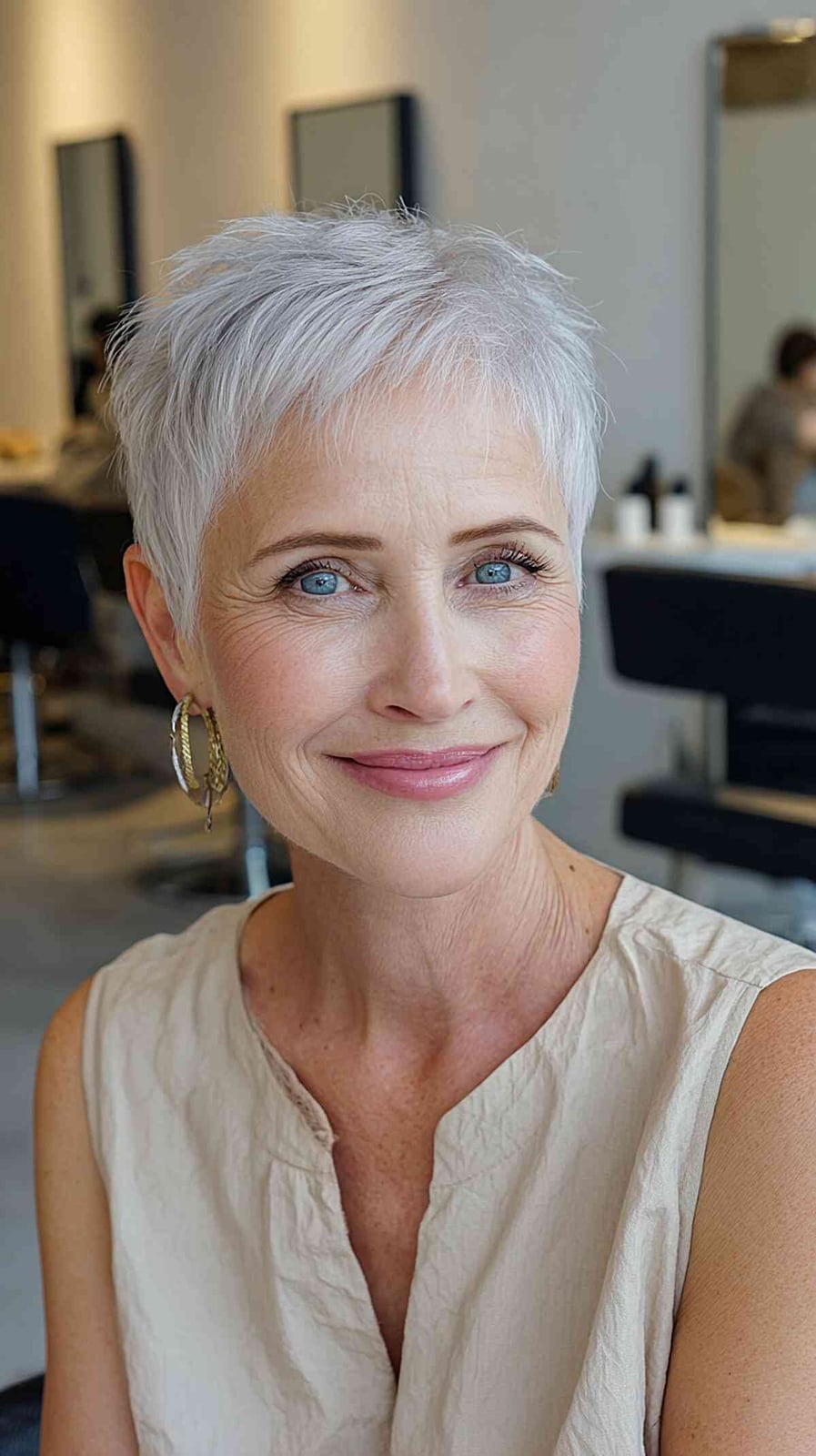 Light Gray Pixie With Textured Wispy Bangs and Reaching The Ear Area Light Gray Pixie With Textured Wispy Bangs and Reaching The Ear Area — Simple Gray Blending