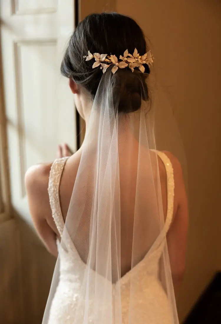 Dark Brown Low Bun With Crown Accessory and Cascading Down Her Back Dark Brown Low Bun With Crown Accessory and Cascading Down Her Back — Simple Hairstyles with Veil