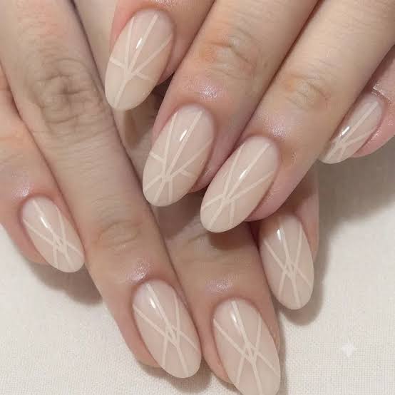 Medium Oval Sheer Nude With White Geometric Lines Medium Oval Sheer Nude With White Geometric Lines — Simple Nail Art Inspo