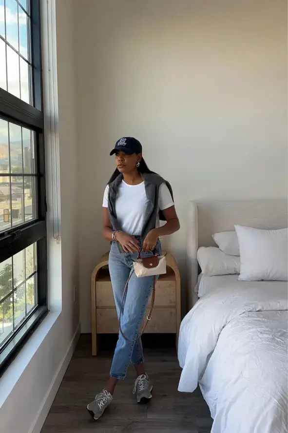 Light Wash Jeans with Sweater Draped Over Shoulders — Simple New Balance Outfits