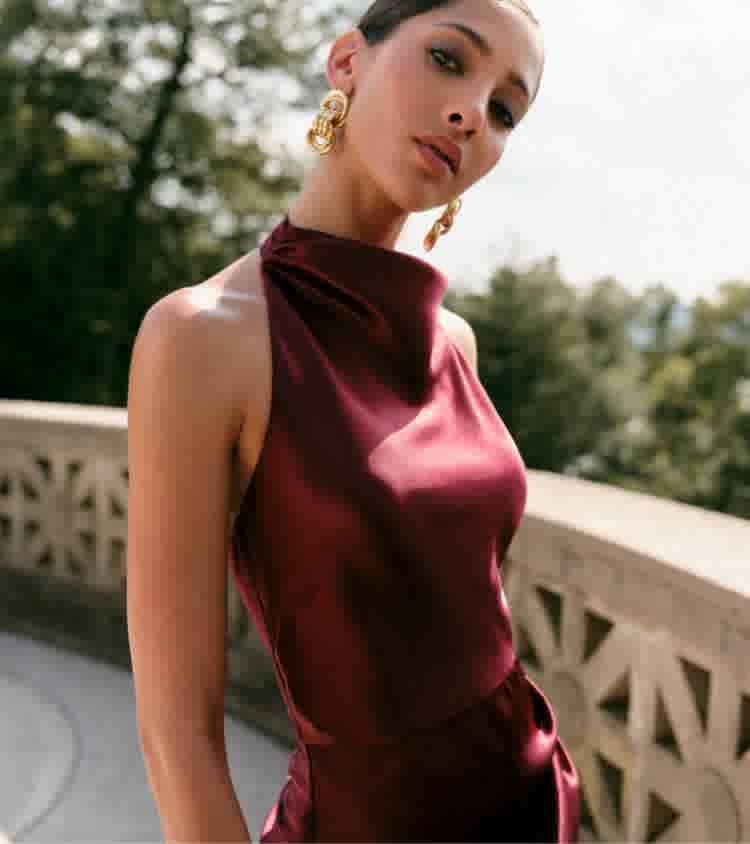 Maroon Satin Halter Neck Dress with Gold Earrings Maroon Satin Halter Neck Dress with Gold Earrings — Simple Wedding Guest Outfits