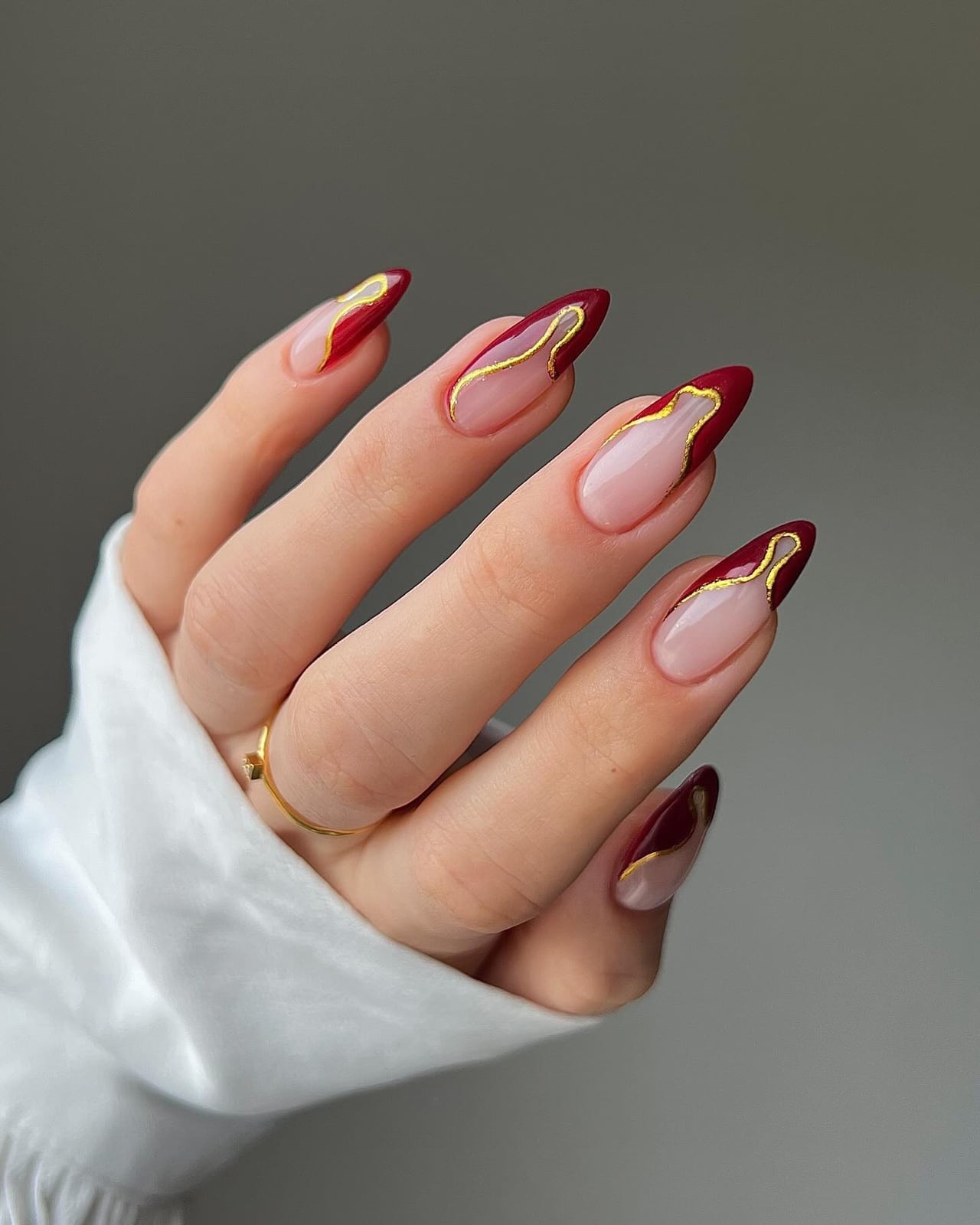 Deep Red Nude Gold Line Almond Nails — Trendy Birthday Nails Almond